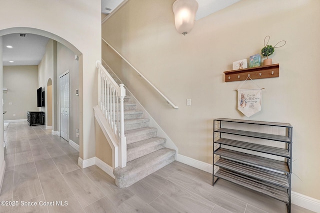 2248 Attilburgh Blvd, West Melbourne, FL 32904 - stairway featuring arched walkways, recessed lighting, and wood finished floors