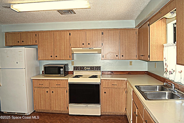 2508 Palmetto Dr, Cocoa, FL 32926 - kitchen featuring white appliances, under cabinet range hood, and light countertops
