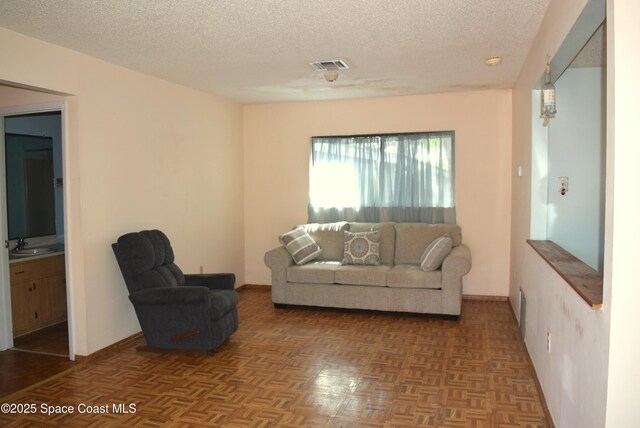 2508 Palmetto Dr, Cocoa, FL 32926 - living area featuring a textured ceiling and baseboards
