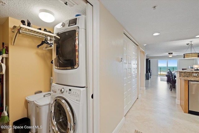 2375 S Atlantic Ave Unit 302, Cocoa Beach, FL 32931 - laundry area with stacked washing machine and dryer, light tile patterned floors, a textured ceiling, and recessed lighting