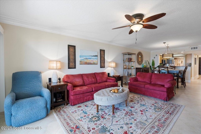 2375 S Atlantic Ave Unit 302, Cocoa Beach, FL 32931 - living room featuring crown molding, a ceiling fan, and a textured ceiling