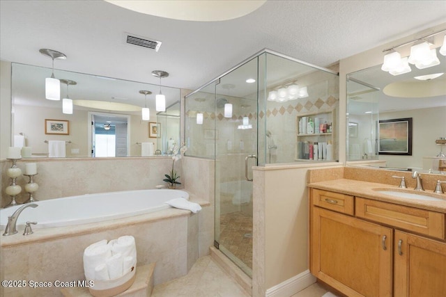 2375 S Atlantic Ave Unit 302, Cocoa Beach, FL 32931 - bathroom with a bath, vanity, a shower stall, and tile patterned floors