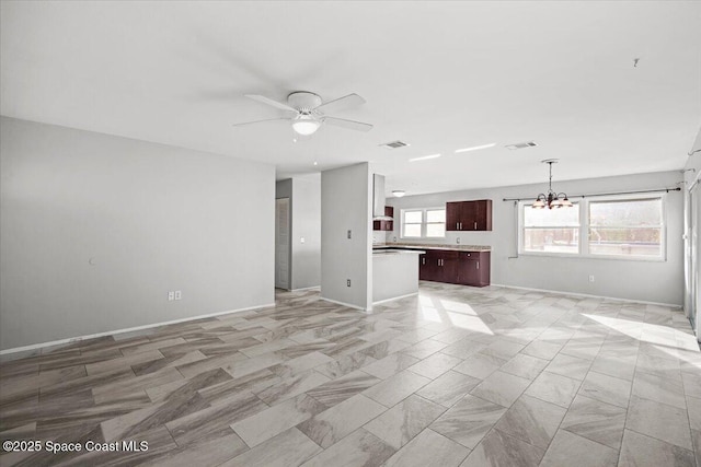 1638 Riviera Dr NE, Palm Bay, FL 32905 - unfurnished living room featuring a chandelier, a ceiling fan, and light marble finish flooring
