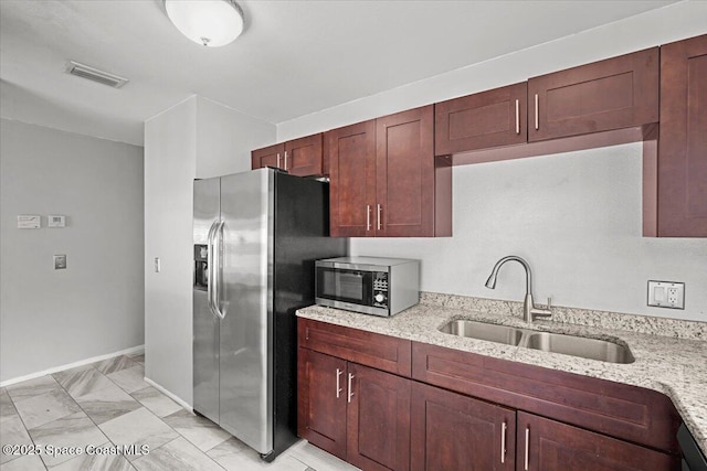 1638 Riviera Dr NE, Palm Bay, FL 32905 - kitchen featuring stainless steel appliances, light stone counters, and light marble finish floors