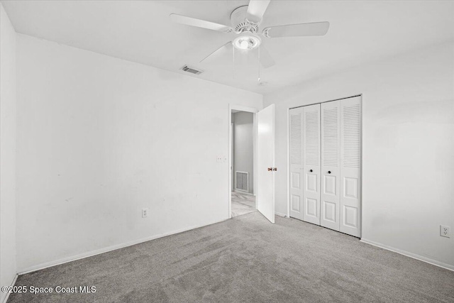1638 Riviera Dr NE, Palm Bay, FL 32905 - unfurnished bedroom with carpet flooring, a closet, and ceiling fan
