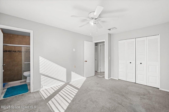 1638 Riviera Dr NE, Palm Bay, FL 32905 - unfurnished bedroom featuring carpet floors, a closet, connected bathroom, and a ceiling fan