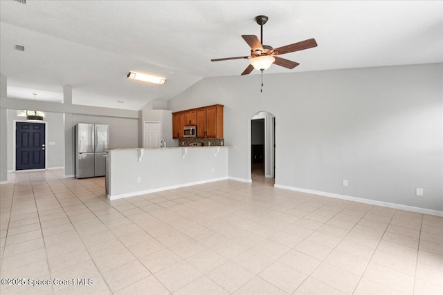 781 Dinner St NE, Palm Bay, FL 32907 - unfurnished living room featuring vaulted ceiling, a ceiling fan, and arched walkways