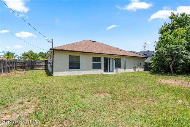 781 Dinner St NE, Palm Bay, FL 32907 - back of property featuring a fenced backyard and stucco siding