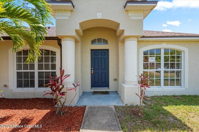 781 Dinner St NE, Palm Bay, FL 32907 - property entrance with stucco siding and roof with shingles