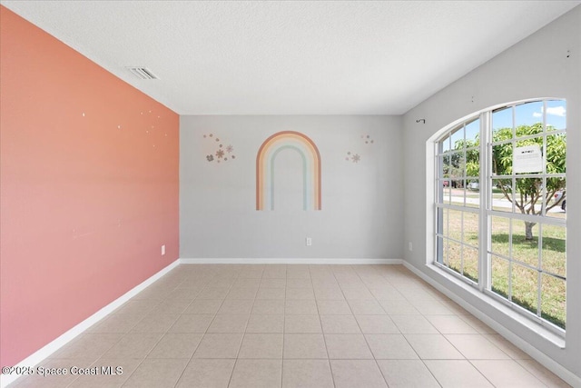 781 Dinner St NE, Palm Bay, FL 32907 - empty room featuring a textured ceiling and baseboards