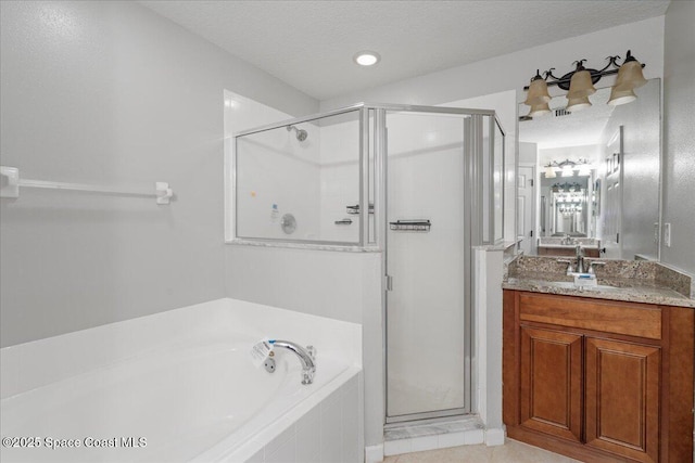 781 Dinner St NE, Palm Bay, FL 32907 - bathroom with a garden tub, a shower stall, vanity, and a textured ceiling