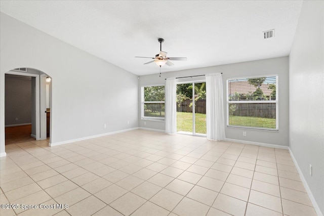 781 Dinner St NE, Palm Bay, FL 32907 - unfurnished room with arched walkways, a ceiling fan, and light tile patterned floors