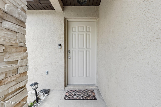 149 Hawthorne Ln NE, Palm Bay, FL 32907 - view of exterior entry with stucco siding
