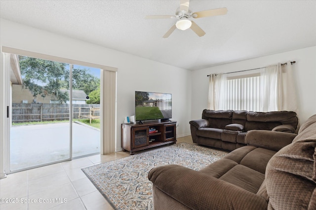 149 Hawthorne Ln NE, Palm Bay, FL 32907 - living area featuring lofted ceiling, light tile patterned floors, and a ceiling fan