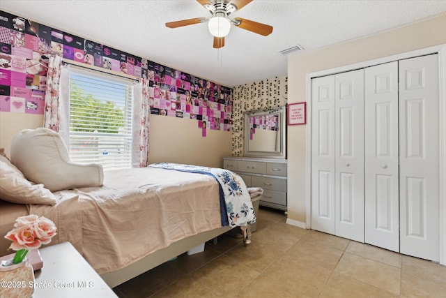 149 Hawthorne Ln NE, Palm Bay, FL 32907 - tiled bedroom featuring a closet, a textured ceiling, and a ceiling fan