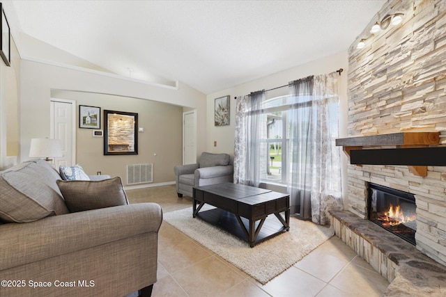 149 Hawthorne Ln NE, Palm Bay, FL 32907 - living area featuring vaulted ceiling, light tile patterned floors, and a fireplace