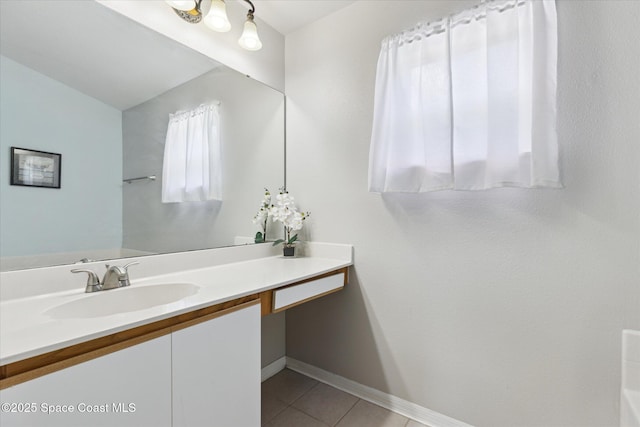 149 Hawthorne Ln NE, Palm Bay, FL 32907 - bathroom with vanity, tile patterned flooring, and vaulted ceiling