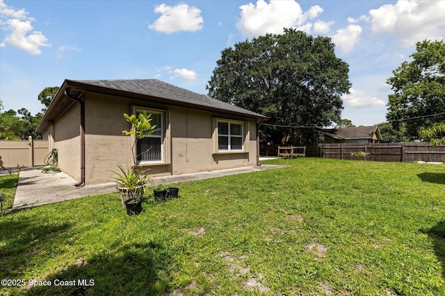 149 Hawthorne Ln NE, Palm Bay, FL 32907 - rear view of property with stucco siding, a fenced backyard, and a patio area