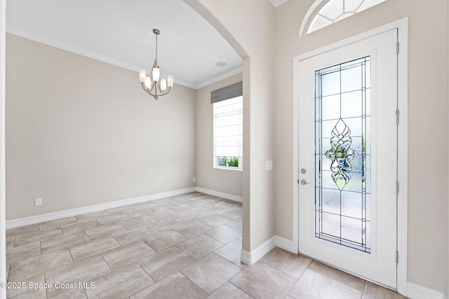 7684 Poulicny Ln, Melbourne, FL 32940 - entrance foyer with arched walkways, crown molding, and a chandelier