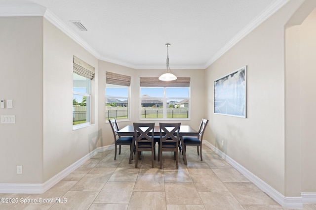 7684 Poulicny Ln, Melbourne, FL 32940 - dining space featuring ornamental molding and light stone finish flooring