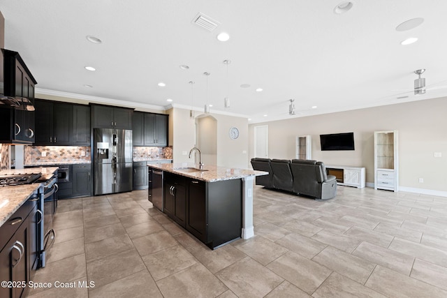 7684 Poulicny Ln, Melbourne, FL 32940 - kitchen with appliances with stainless steel finishes, tasteful backsplash, crown molding, recessed lighting, and light stone counters