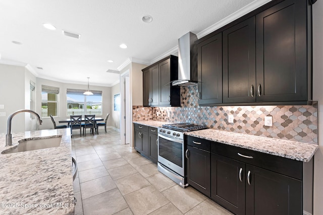 7684 Poulicny Ln, Melbourne, FL 32940 - kitchen with stainless steel gas range oven, wall chimney exhaust hood, ornamental molding, tasteful backsplash, and light stone countertops