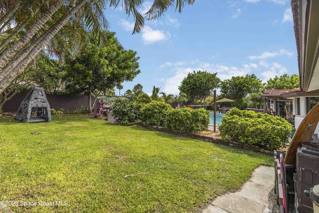 305 Sand Pine Rd, Indialantic, FL 32903 - view of green lawn with an outdoor pool