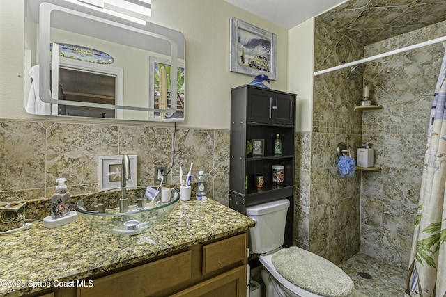 449 Amity Ave, Cocoa, FL 32927 - bathroom featuring tiled shower, vanity, and a wainscoted wall