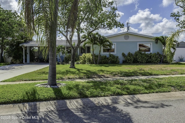 449 Amity Ave, Cocoa, FL 32927 - ranch-style house featuring driveway, stucco siding, a front lawn, and a carport