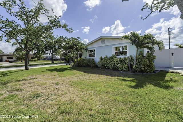 449 Amity Ave, Cocoa, FL 32927 - view of home's exterior featuring a yard, a gate, and stucco siding
