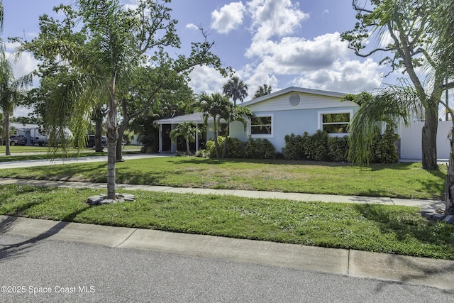 449 Amity Ave, Cocoa, FL 32927 - single story home with a front lawn, concrete driveway, and a carport