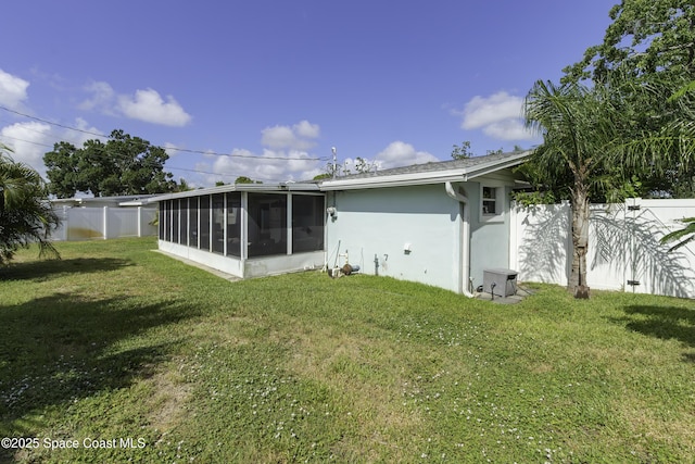 449 Amity Ave, Cocoa, FL 32927 - rear view of property featuring a sunroom, stucco siding, and a fenced backyard