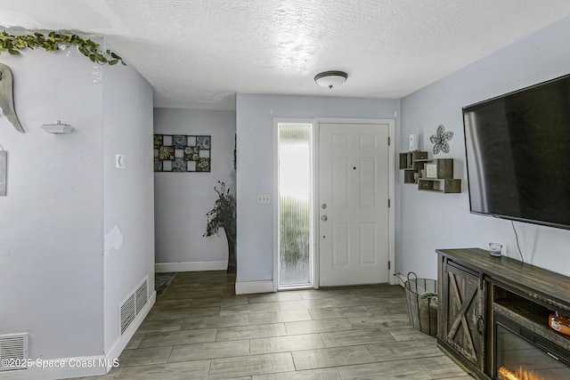 449 Amity Ave, Cocoa, FL 32927 - foyer entrance featuring a textured ceiling and baseboards