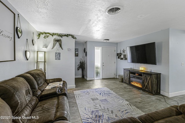 449 Amity Ave, Cocoa, FL 32927 - living area featuring a textured ceiling and wood finished floors