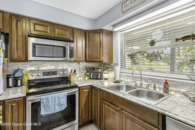 449 Amity Ave, Cocoa, FL 32927 - kitchen featuring appliances with stainless steel finishes, decorative backsplash, and light stone counters