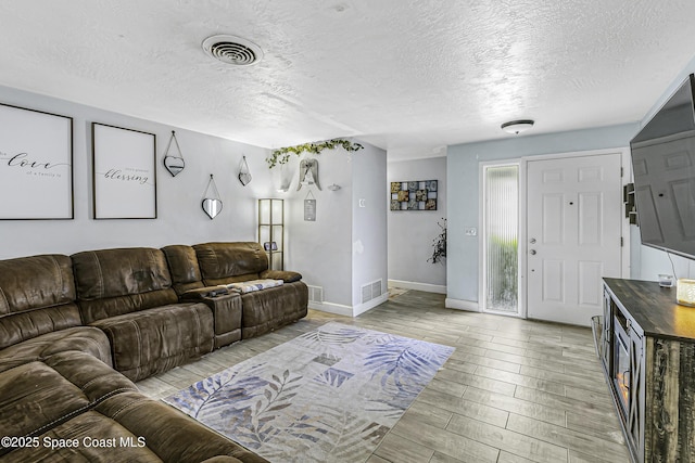 449 Amity Ave, Cocoa, FL 32927 - living room with a textured ceiling and light wood-type flooring