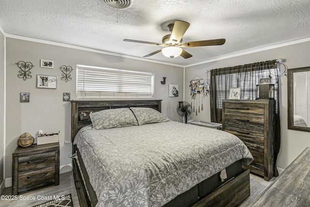 449 Amity Ave, Cocoa, FL 32927 - bedroom with wood finished floors, ornamental molding, a textured ceiling, and a ceiling fan