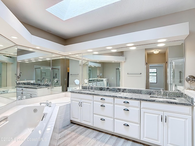 3090 Rio Pino S, Indialantic, FL 32903 - full bath featuring a shower stall, a skylight, a tub with jets, double vanity, and recessed lighting
