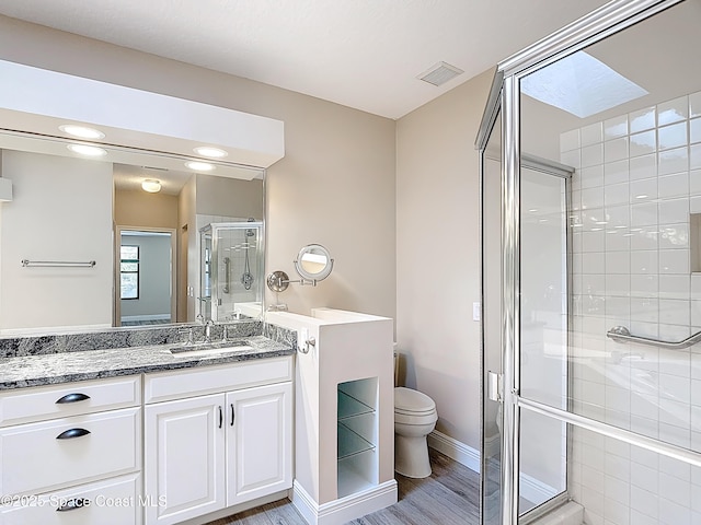 3090 Rio Pino S, Indialantic, FL 32903 - bathroom featuring vanity, a stall shower, and wood finished floors