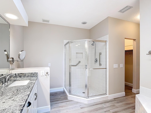 3090 Rio Pino S, Indialantic, FL 32903 - full bath featuring a stall shower, vanity, a walk in closet, and wood finished floors