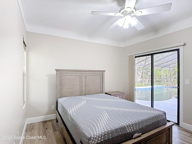 3090 Rio Pino S, Indialantic, FL 32903 - bedroom featuring access to exterior, light wood finished floors, crown molding, ceiling fan, and a textured ceiling