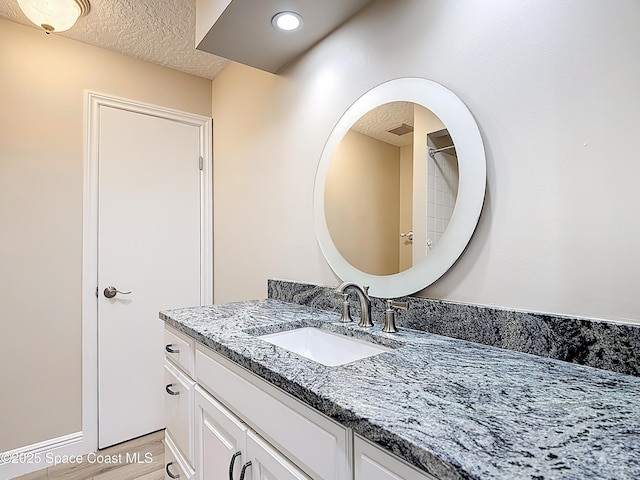 3090 Rio Pino S, Indialantic, FL 32903 - bathroom featuring vanity, wood finished floors, and a textured ceiling