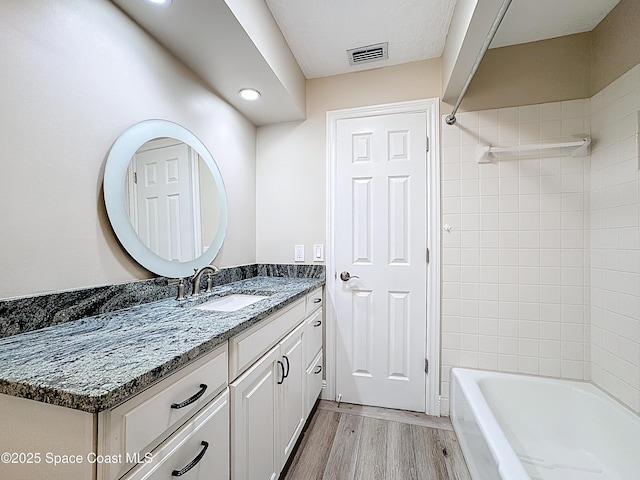 3090 Rio Pino S, Indialantic, FL 32903 - full bathroom featuring vanity, wood finished floors, shower / washtub combination, and recessed lighting