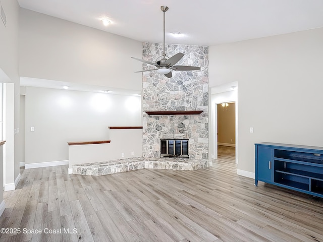 3090 Rio Pino S, Indialantic, FL 32903 - unfurnished living room with high vaulted ceiling, ceiling fan, wood finished floors, and a fireplace