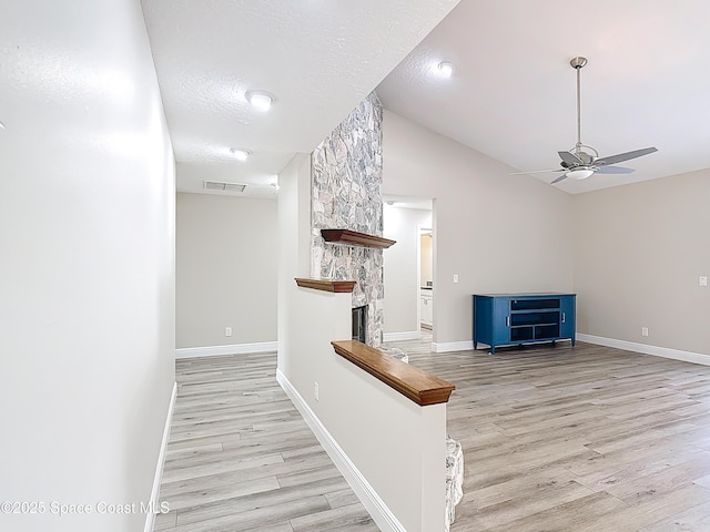 3090 Rio Pino S, Indialantic, FL 32903 - hall featuring light wood finished floors, lofted ceiling, and a textured ceiling