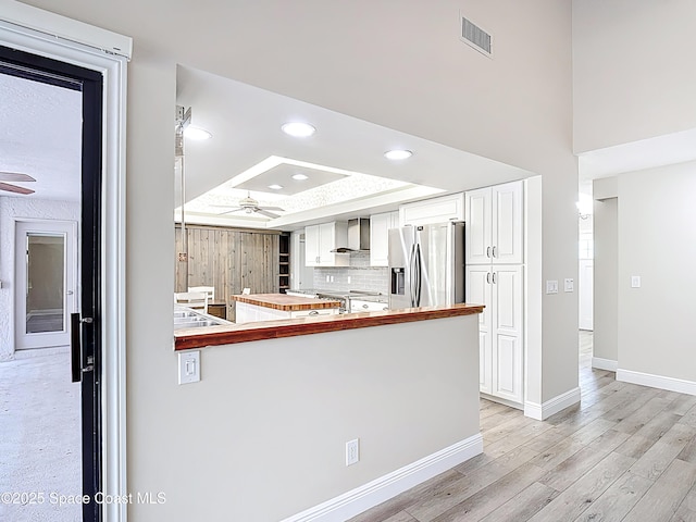 3090 Rio Pino S, Indialantic, FL 32903 - kitchen featuring stainless steel fridge, ceiling fan, white cabinets, recessed lighting, and light wood finished floors
