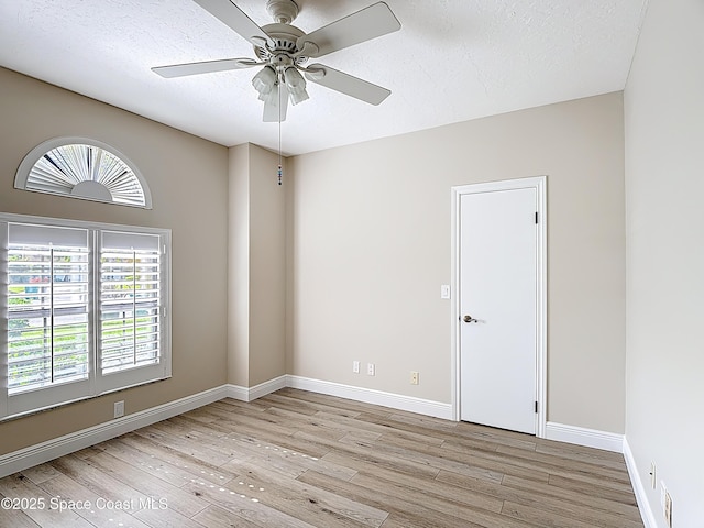 3090 Rio Pino S, Indialantic, FL 32903 - empty room with light wood-style floors, a ceiling fan, and a textured ceiling
