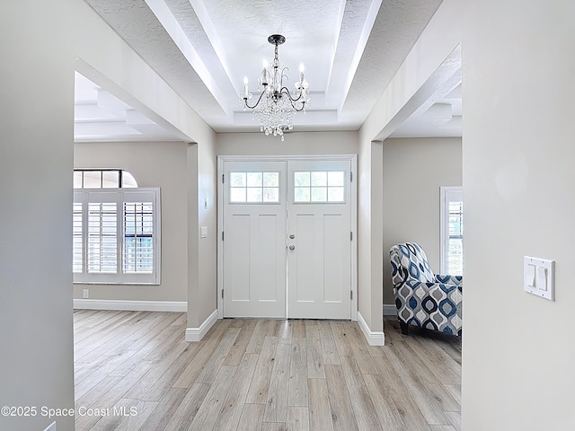 3090 Rio Pino S, Indialantic, FL 32903 - entrance foyer with a raised ceiling, a chandelier, and light wood-type flooring