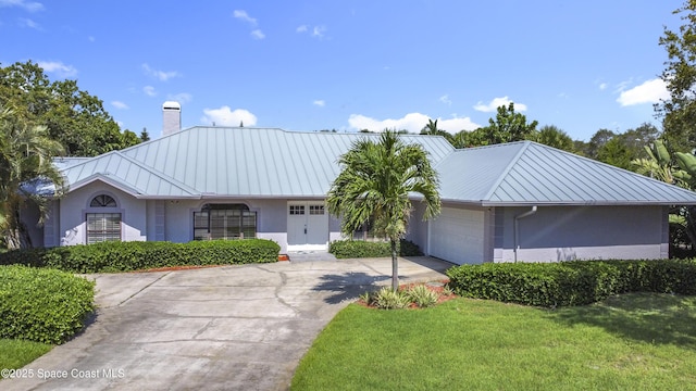 3090 Rio Pino S, Indialantic, FL 32903 - ranch-style house with stucco siding, a chimney, a metal roof, and a standing seam roof