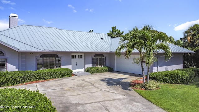 3090 Rio Pino S, Indialantic, FL 32903 - ranch-style home featuring a standing seam roof, a metal roof, stucco siding, and an attached garage